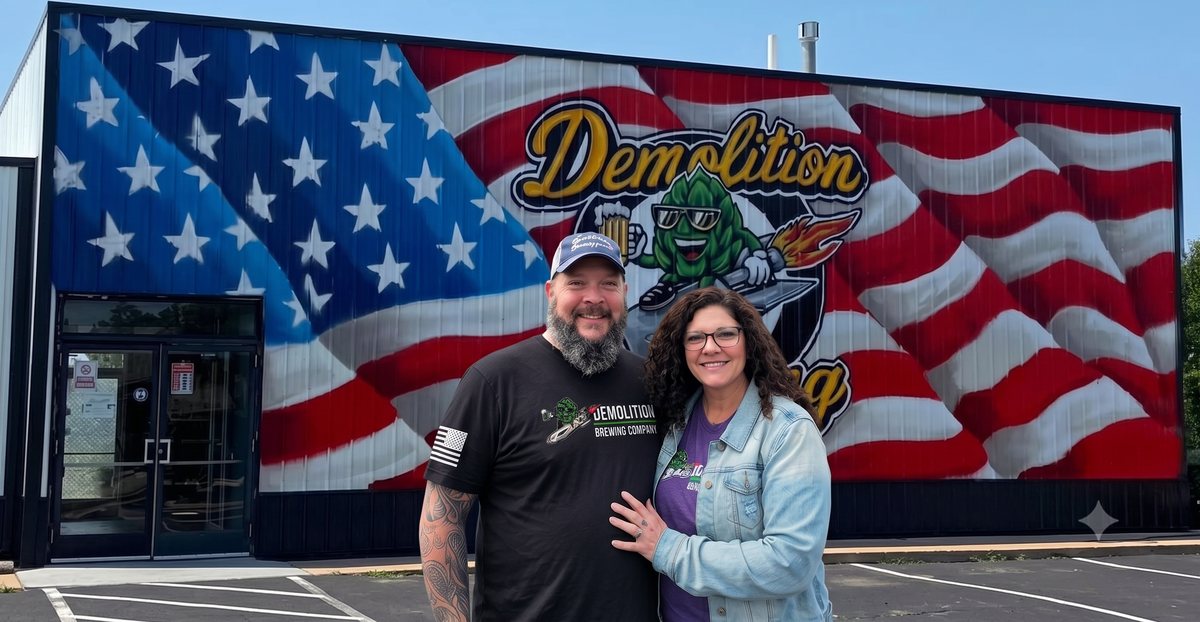 The founders of Demolition Brewing Company in front of the flag mural, Laurie, Missouri